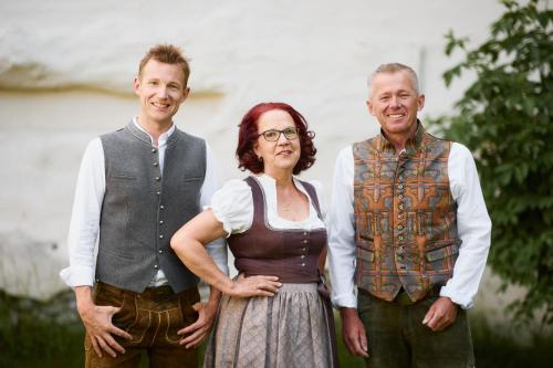 a woman and two men standing next to each other at Gasthaus Hotel Oberwirt in Ebbs