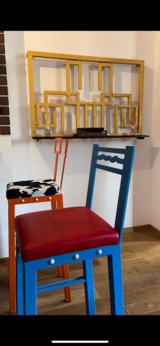 a blue and red chair sitting next to a counter at Sava apartment in Novi Sad