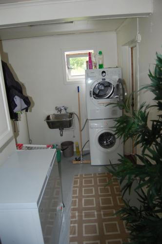 a kitchen with a washing machine and a sink at Feriehus nede ved sjøen inntil 6 pers in Vestnes