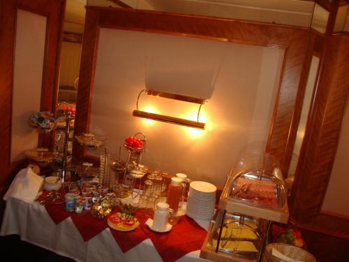 a table with a white table cloth and plates on it at Hotel Bajazzo in Vienna