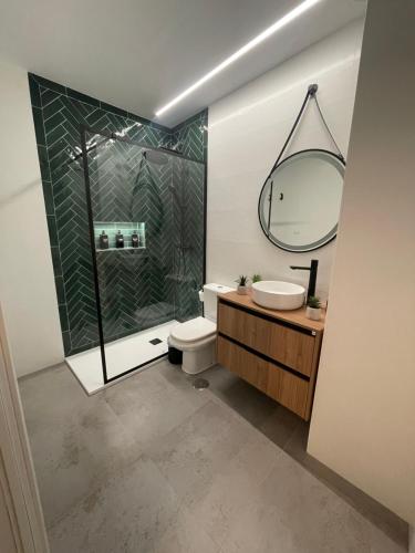 a bathroom with a shower and a toilet and a sink at WISH SUITE PONCE DE LEON in Seville