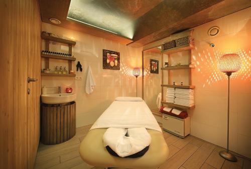 a hospital room with a bed and a sink at Absolutum Wellness Hotel in Prague