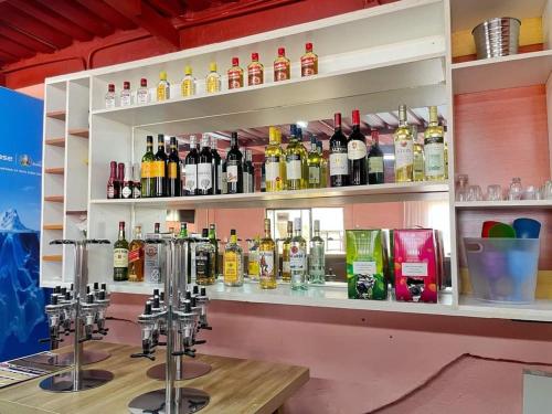 a bar with a lot of bottles of alcohol at Keeme-Nao Hotel in Mahalapye