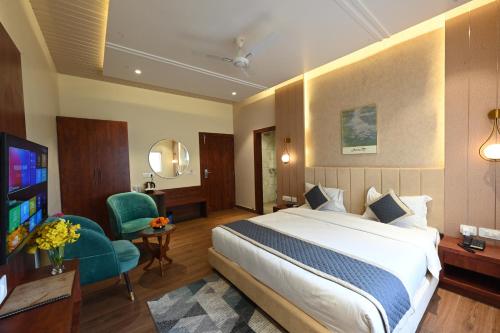 a hotel room with a bed and a television at THE GANGA RESORT in Bikaner
