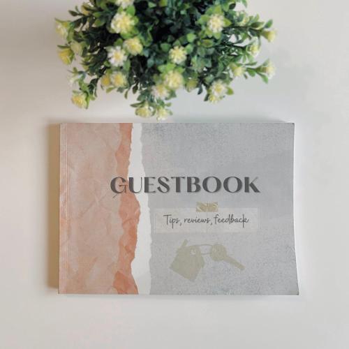 a book sitting on a wall with a plant at Villa Noga Rooms in Selargius