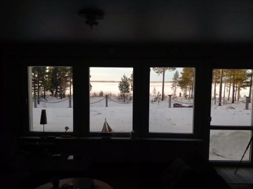 a window with a view of a snow covered field at Havsnära villa in Nordmaling