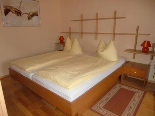a bed with white sheets and pillows in a room at Ferienwohnung für 5 Personen in Radewege, Berlin in Radewege