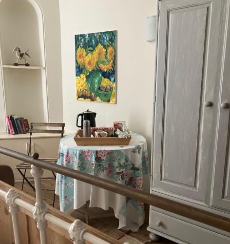 a table with a tea kettle on it in a room at Bailey House in Devizes