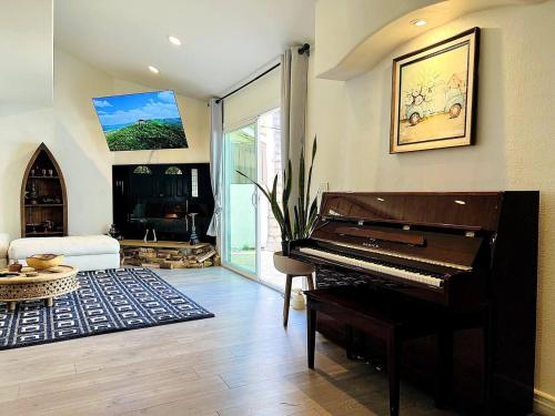 a living room with a piano and a couch at Mediterranean Villa Pool & Jacuzzi & BBQ Malibu & Hollywood Bliss in Los Angeles