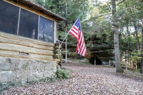 an american flag on the side of a cabin at Russell Cabin in Logan