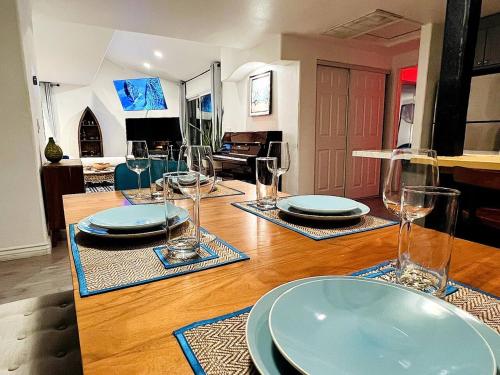 a table with plates and glasses on top of it at Los Angeles Hideaway - Villa Costanso in Los Angeles