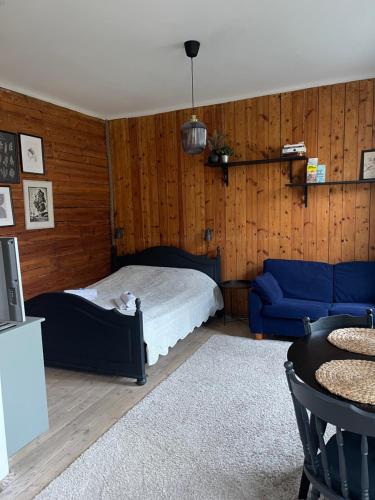 a bedroom with a bed and a blue couch at Hipster’s Kalamaja Studio Apartment in Tallinn