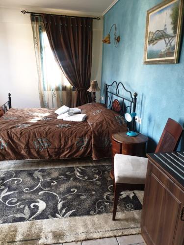 a bedroom with a bed and a table and a chair at ''EPAVLIS boutique GALAXIDI'' in Galaxidhion