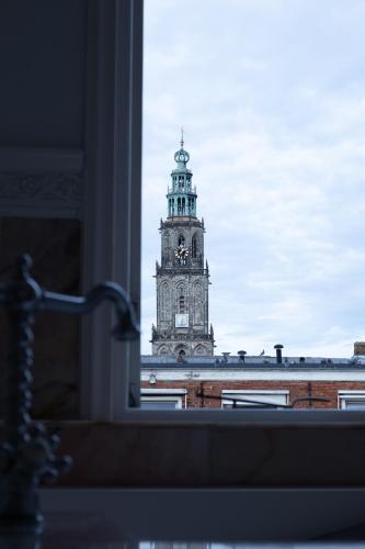 a clock tower on top of a building at Hotel Schimmelpenninck Huys in Groningen