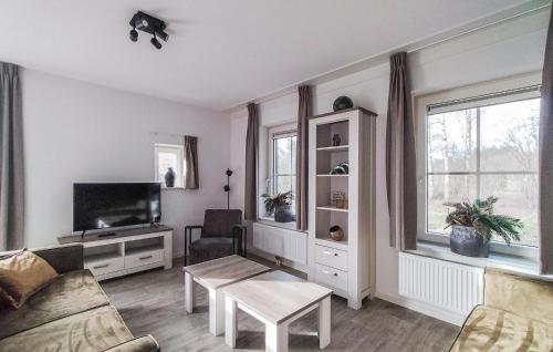 a living room with a couch and a tv at Amazing Home In Den Ham With Sauna in Den Ham