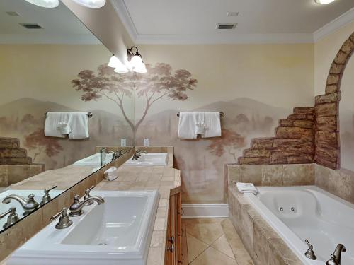a bathroom with two sinks and a bath tub at Adagio 203E in Santa Rosa Beach