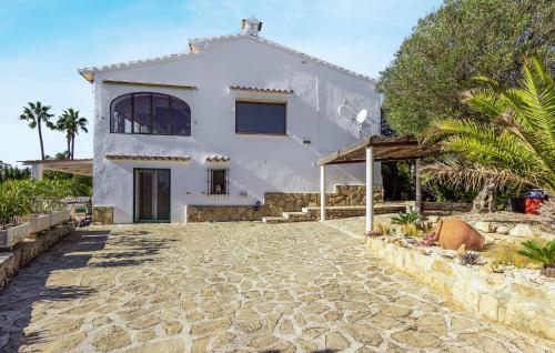 a white house with a stone driveway at Nice Home In Jávea With Wifi in Jávea