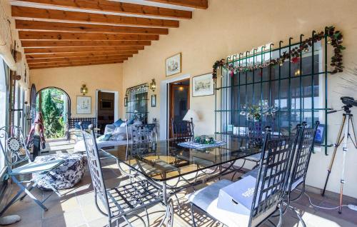 a dining room with a glass table and chairs at Nice Home In Jávea With Wifi in Jávea