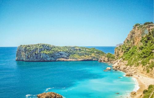 a view of a beach with a large rock formation at Nice Home In Jávea With Wifi in Jávea