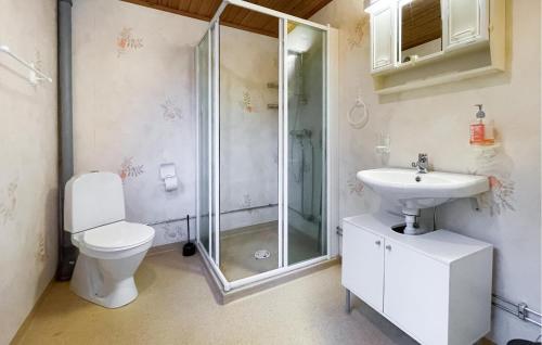 a bathroom with a shower and a toilet and a sink at Amazing Home In Kinnahult With Wifi in Kinnahult