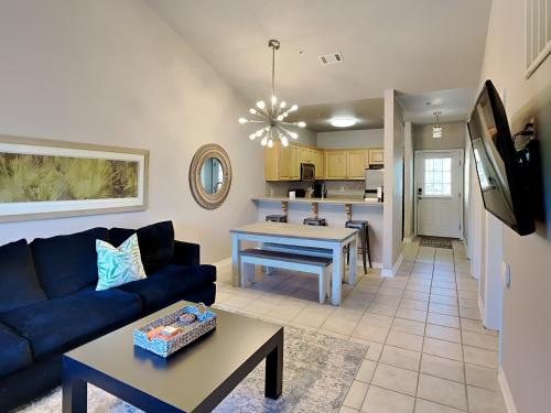 a living room with a blue couch and a table at Herons Watch #5311 in Seagrove Beach