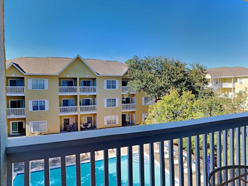 a balcony with a view of a building at Herons Watch #5311 in Seagrove Beach