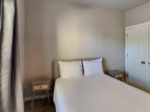 a bedroom with a white bed with two pillows at Herons Watch #5311 in Seagrove Beach