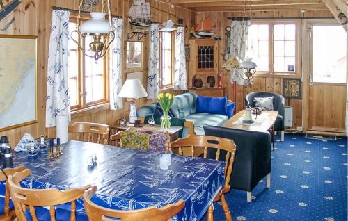 a dining room with blue tables and chairs at Beautiful Home In Kolbjrnsvik With 2 Bedrooms And Wifi 