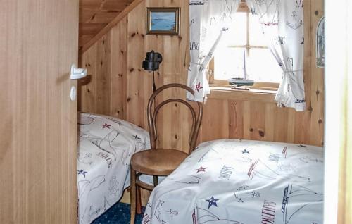 um quarto com uma cama, uma cadeira e uma janela em Stunning Home In Kolbjrnsvik With Kitchen 