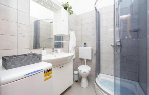 a bathroom with a sink and a toilet and a shower at Amazing Apartment In Slime With Wifi in Slime