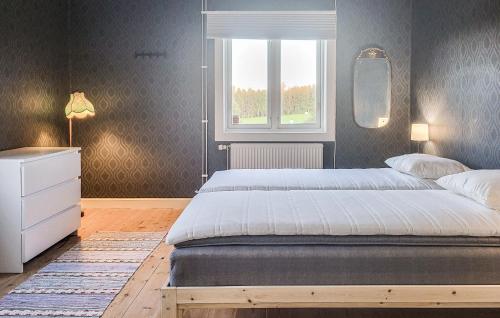 a bedroom with a large bed and a window at Stunning Home In Klässbol With Kitchen in Klässbol