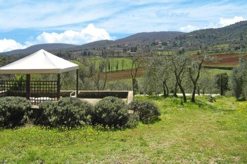 a gazebo with a white umbrella in a field at Apartment in Sovicille with heating in Sovicille