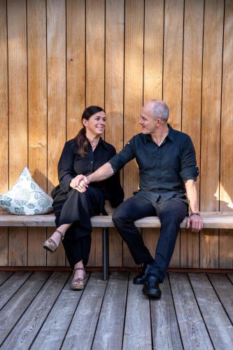 a man and a woman sitting on a bench at Schlegelhof in Kirchzarten