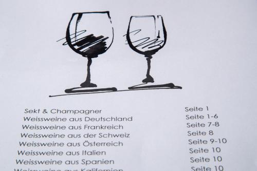 a drawing of two wine glasses on a menu at Schlegelhof in Kirchzarten
