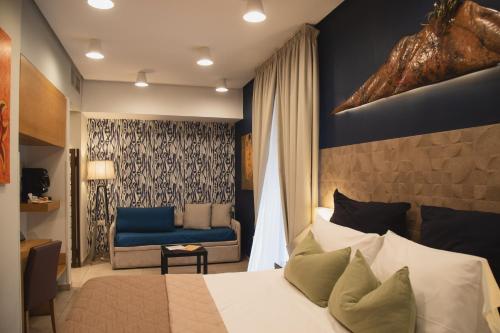 a hotel room with a bed and a chair at Airone Hotel in Naples