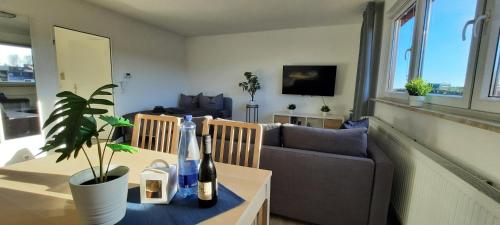 a living room with a couch and a table with a plant at Apartment Horizont in Bad Sachsa