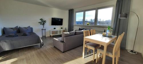 a living room with a bed and a couch and a table at Apartment Horizont in Bad Sachsa