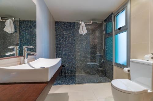 a bathroom with a sink and a shower at Silver Sands Penthouse in Protaras
