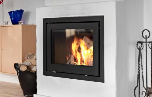 a fireplace in a living room with a fire at Beautiful Home In Dronningmølle in Dronningmølle