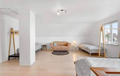 a white living room with a chair and a couch at Gorgeous Home In Sby r With Wifi in Søby