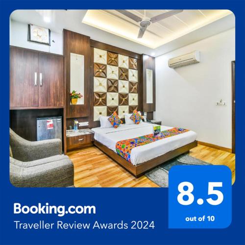 a hotel room with a bed and a chair at FabHotel Aman Residency Sharifpura in Amritsar