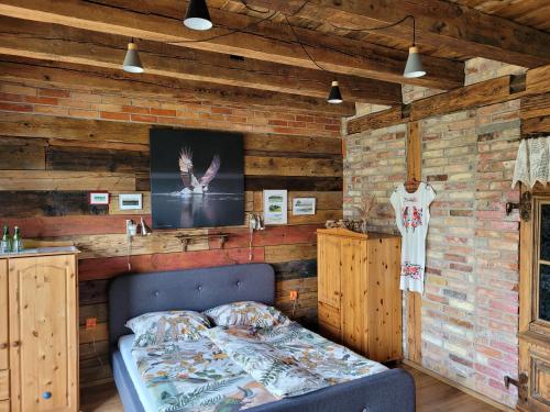 a bedroom with a bed and a brick wall at DOM GOŚCINNY PTASZARNIA - NATURA-Free PARKING in Świnoujście