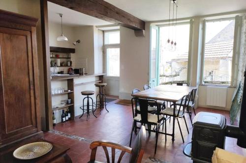 a kitchen and dining room with a table and chairs at Les Hirondelles et la glycine in Montréal