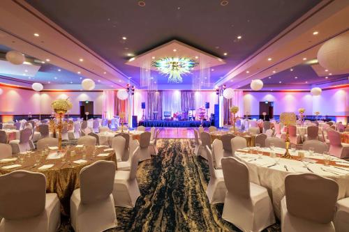 a banquet hall with tables and chairs and a chandelier at Hilton Aruba Caribbean Resort & Casino in Palm-Eagle Beach