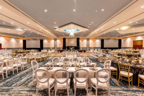 a banquet hall with white tables and chairs at Hilton Aruba Caribbean Resort & Casino in Palm-Eagle Beach