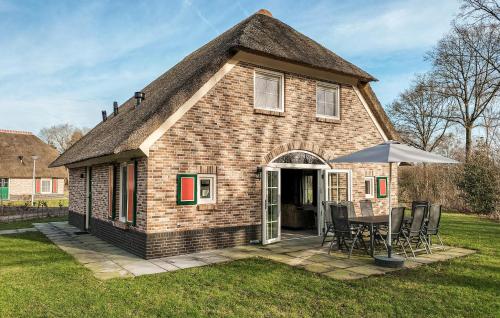 a small brick house with a table and chairs at Beautiful Home In Den Ham With Kitchen in Den Ham