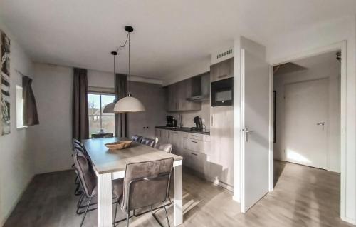 a kitchen with a table and chairs in a room at Beautiful Home In Den Ham With Kitchen in Den Ham