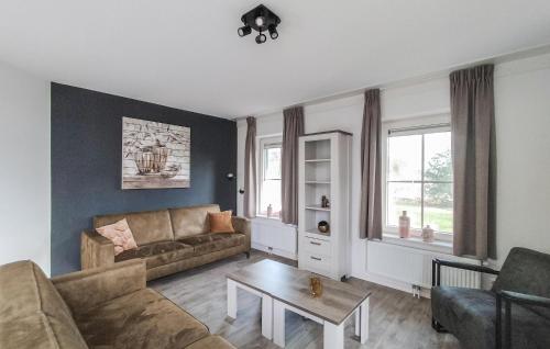a living room with a couch and a table at Beautiful Home In Den Ham With Kitchen in Den Ham