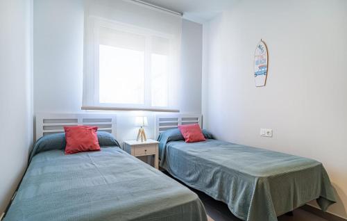a bedroom with two beds and a window at Stunning Apartment In Chipiona With Wi-fi in Chipiona