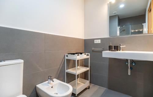 a bathroom with a white toilet and a sink at Stunning Apartment In Chipiona With Wi-fi in Chipiona